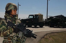 Airman 1st Class Candace Edwards, 5th Security Forces Squadron, stands guard at the weapons storage area April 24 as a movement of cruise missiles goes back into storage after a B-52H generation exercise April 20 - 23. (U.S. Air Force photo by Staff Sgt. Jocelyn Rich)
