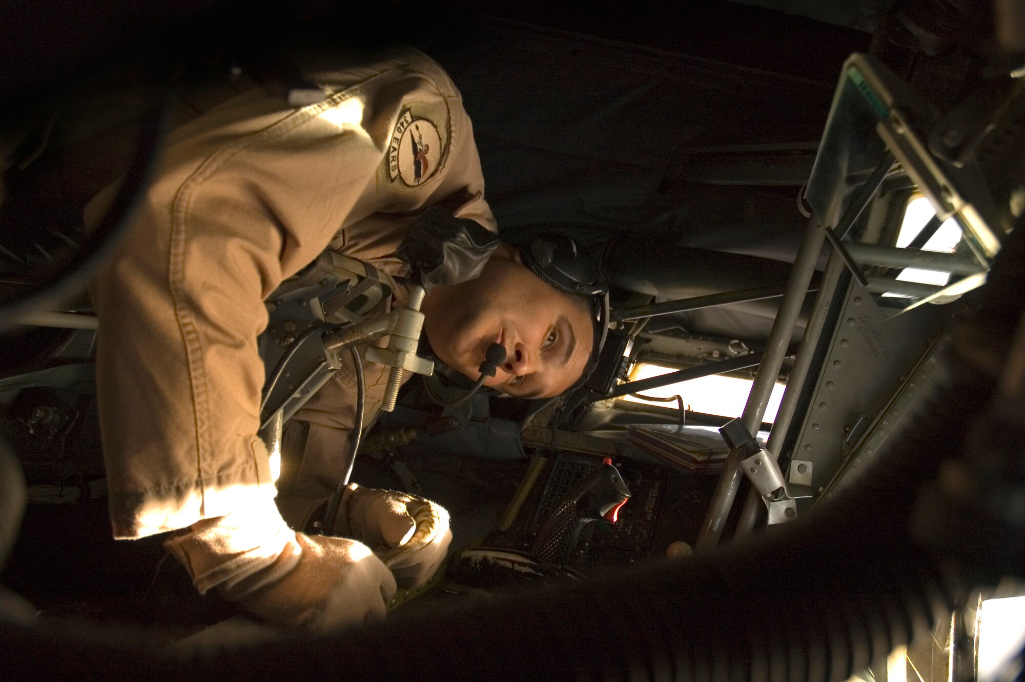 Staff Sgt. Anthony Krisher uses the mirrors in the boom pod of a KC-135R Stratotanker to check the air refueling boom before he refuels F-15E Strike Eagles over Iraq on Tuesday, April 18, 2006. Sergeant Krisher is a boom operator with the 340th Expeditionary Air Refueling Squadron. He is deployed from the 434th Air Refueling Wing at Grissom Air Reserve Base, Ind. (U.S. Air Force photo/Senior Airman Mark R.W. Orders-Woempner)