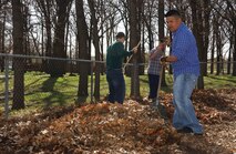 Airman 1st Class Michael Balmaceda, 91st Missile Security Forces Squadron, rakes leaves as a volunteer to help with spring clean-up of Oak Park in Minot April 25. (U.S. Air Force photo by Staff Sgt. Jocelyn Rich)