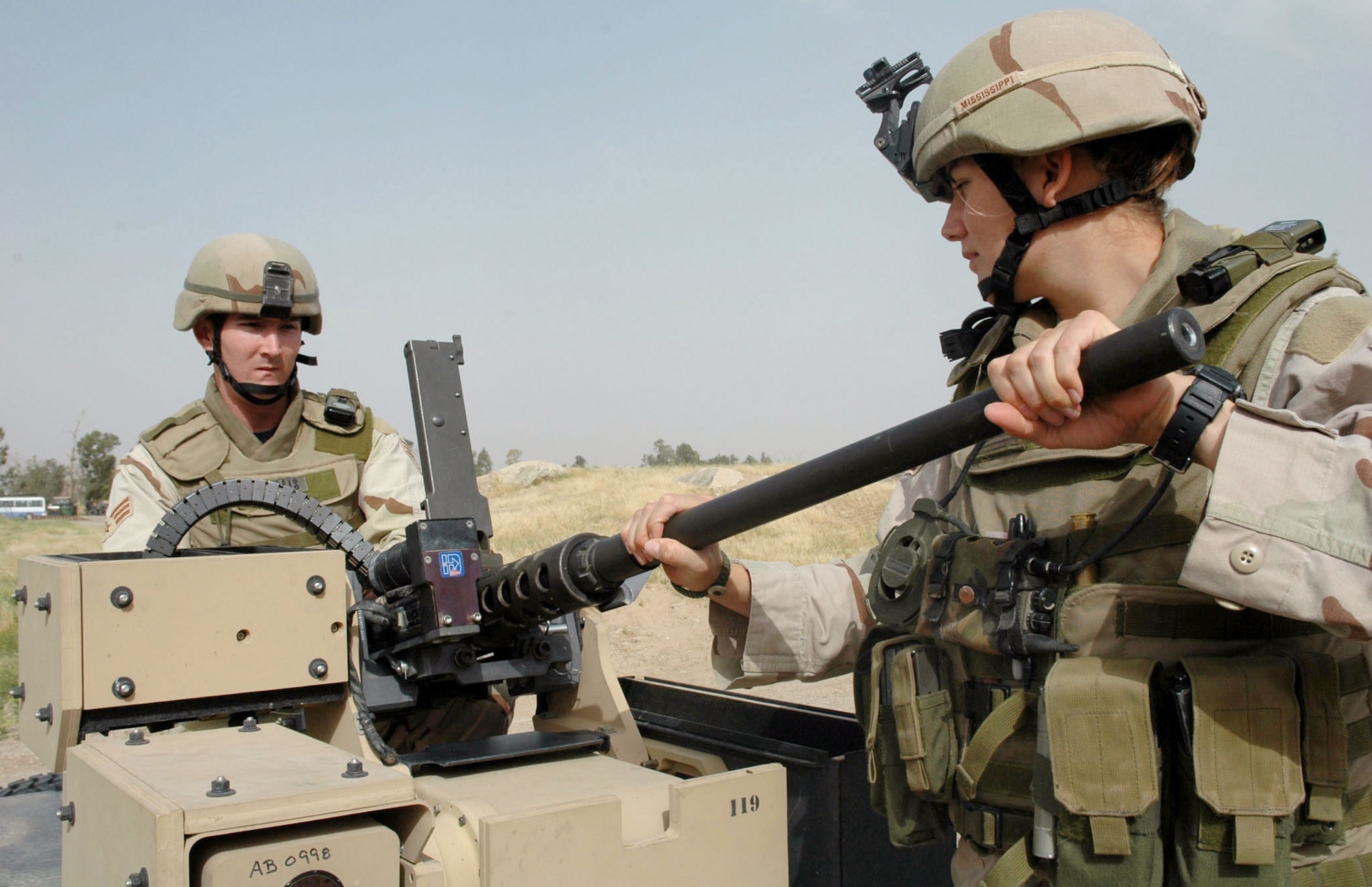 Senior Airmen Jeffrey Oats and Kesha Snedeker assemble a machine gun attached to the Common Remote Operated Weapon Station, or CROWS, on a Humvee at Kirkuk Air Base, Iraq, on Tuesday, April 25, 2006. The CROWS system takes Airmen out of the gun turret and allows a variety of weapons to be remotely operated from the inside the vehicle. Airmen Oats and Snedeker are assigned to the 506th Expeditionary Security Forces Squadron and are deployed from Moody Air Force Base, Ga. (U.S. Air Force photo/Staff Sgt. Kristina Barrett)
