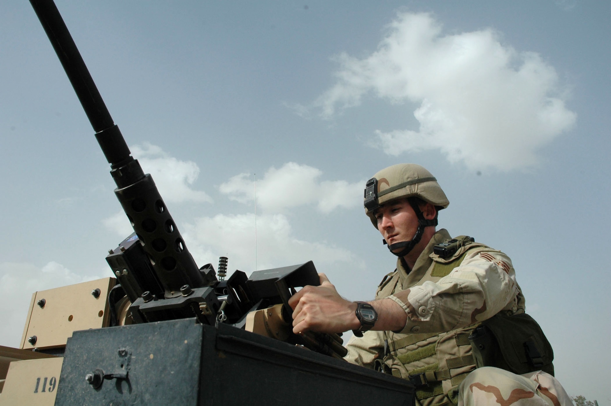 Senior Airman Jeffrey Oats loads ammunition into a machine gun mounted on the Common Remote Operated Weapon Station, or CROWS. This system allows Airmen to operate a variety of weapons remotely from inside the safety of a vehicle. Airman Oats is a gunner assigned to the 506th Expeditionary Security Forces Squadron and is deployed from Moody Air Force Base, Ga. (U.S. Air Force photo/Staff Sgt. Kristina Barrett)