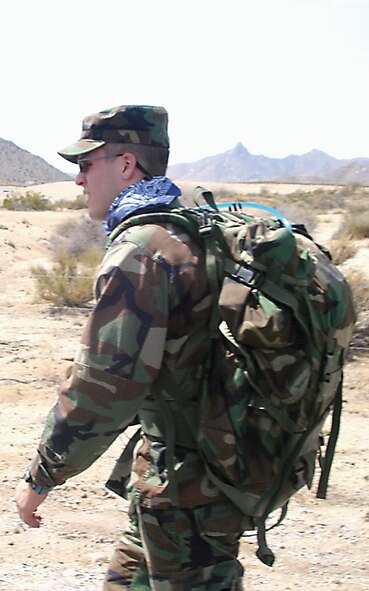 Cadet Robert Meeks hikes along an unpaved path during the march. The cadets used bandannas to shield their necks from the desert sun. (Courtesy photo)