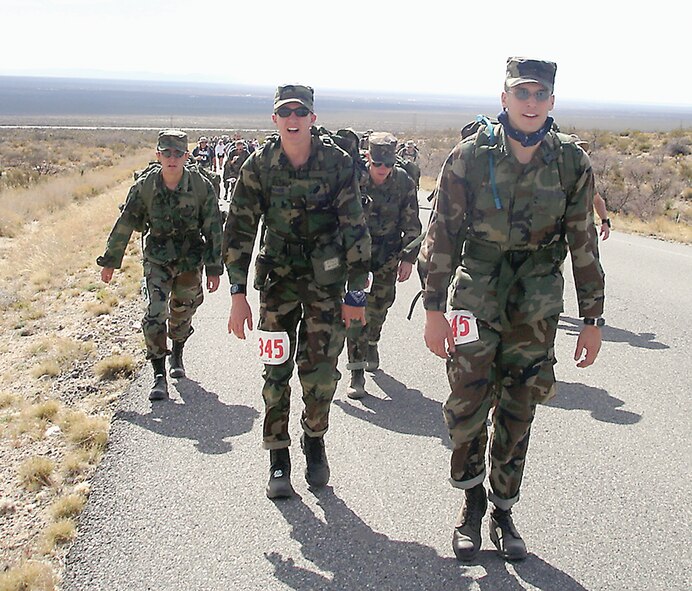 Cadets Daniel Fischer (center) and Robert Meeks (right), Air Force ROTC cadets at Valdosta State University, struggle up a hill nearing the half-way point of the 26.2-mile Bataan Memorial Death March at White Sands Missile Range, N.M. A five-man team from the ROTC detachment finished the march in less than eight hours and placed seventh out of 16 ROTC teams in the team-heavy category, which required participants to wear full military uniform and carry a 35-pound ruck-sack.  (Courtesy photo)