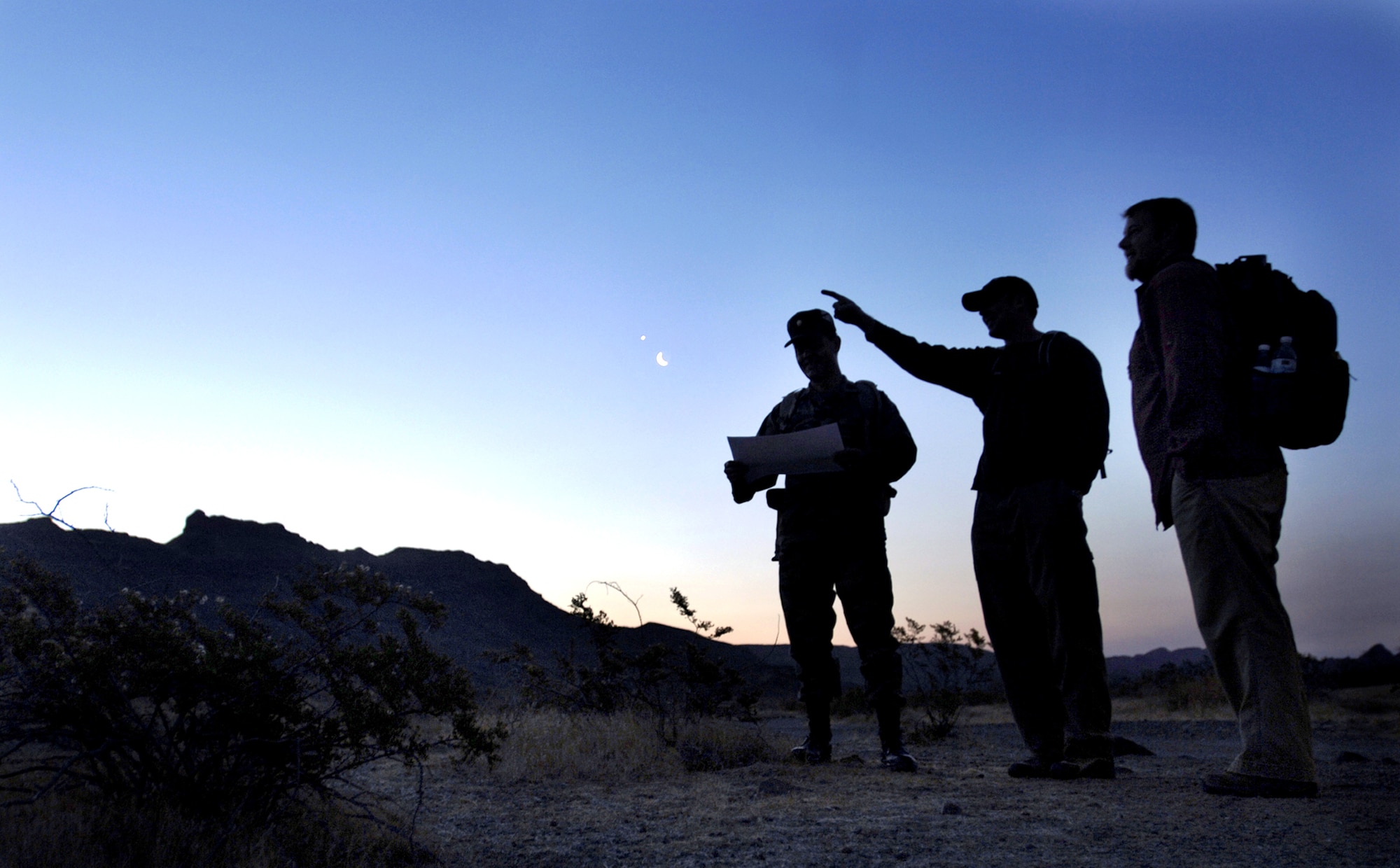 J.T. Hesse shows Maj. Daniel Garcia and Erik Stenehjem where pronghorn antelope were found on the Barry M. Goldwater Range in Phoenix, Ariz., April 24, 2006. The men were conducting a routine pronghorn clearance. Once no sign of the antelope is found, mission bombings and strafing can continue on the range.  (U.S. Air Force photo/Tech. Sgt. Cecilio M. Ricardo Jr.) 