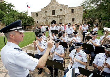 Maj. Dean Zarmbinski conducts the Air Force Band of the West in front of the Alamo during the opening ceremony of Fiesta, a 10-day celebration in San Antonio, on Friday, April 21, 2006.  Major Zarmbinski is the band commander.  (U.S. Air Force photo/Robbin Cresswell)       