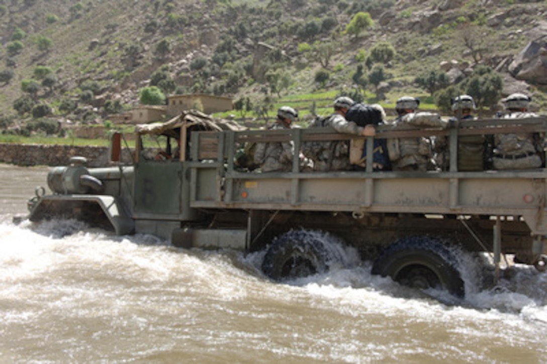 A truck full of U.S. Army soldiers fords the Pech River in Pech Valley, Afghanistan, during operations on April 9, 2006. The soldiers are attached to Charlie Company, 1st Battalion, 32nd Infantry Regiment. 