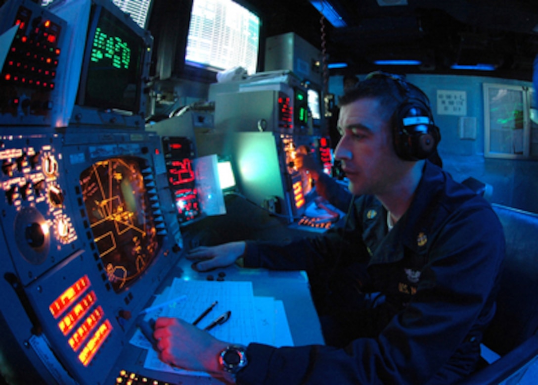 Chief Petty Officer John Bowler plots contacts in the Combat Direction Center aboard the aircraft carrier USS George Washington (CVN 73) as the ship operates in the Caribbean Sea on April 22, 2006. The George Washington Carrier Strike group is participating in Partnership of the Americas, a maritime training and readiness deployment of U.S. Naval Forces along with navies of Caribbean and Latin American countries for enhanced maritime security. 