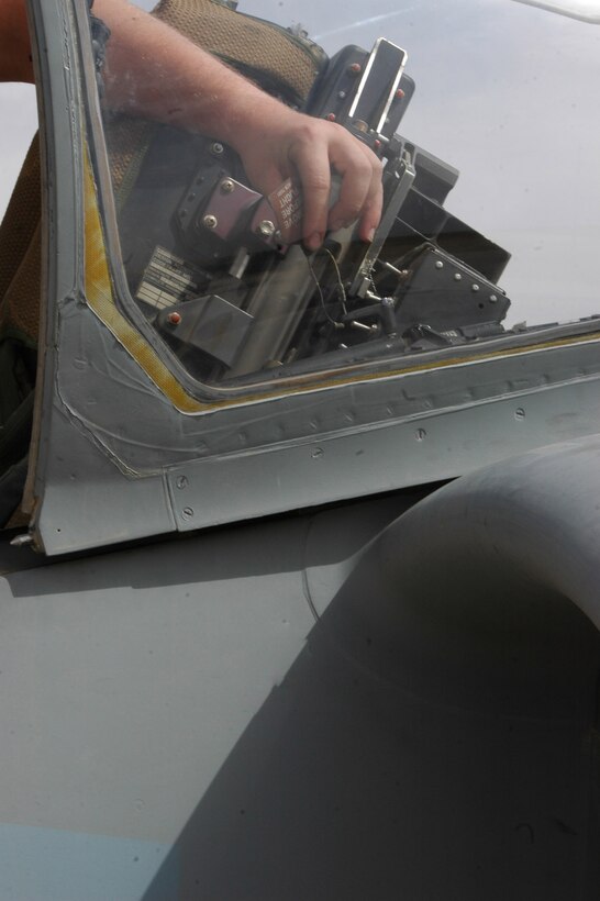 A Marine from Marine Attack Squadron 513, Marine Aircraft Group 16 (Reinforced), 3rd Marine Attack Wing's, ejection seat shop inspects the ejection seat for any discrepancies on the flight line in Al Asad, Iraq April 29. Ejection seat shop Marines have many responsibilities including the avionics cooling system as well as the cockpits heating and cooling systems.