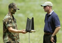 A basic cadet holds the controller for an unmanned aerial vehicle used during a Remote Operated Video Enhanced Receiver demonstration July 28 at the U.S. Air Force Academy. The ROVER is basically a laptop with antennas that receives video captured by a UAV that shows real-time, nearby dangers allowing ground troops to make quick decisions regarding air strikes. (U.S. Air Force photo/Dennis Rogers)