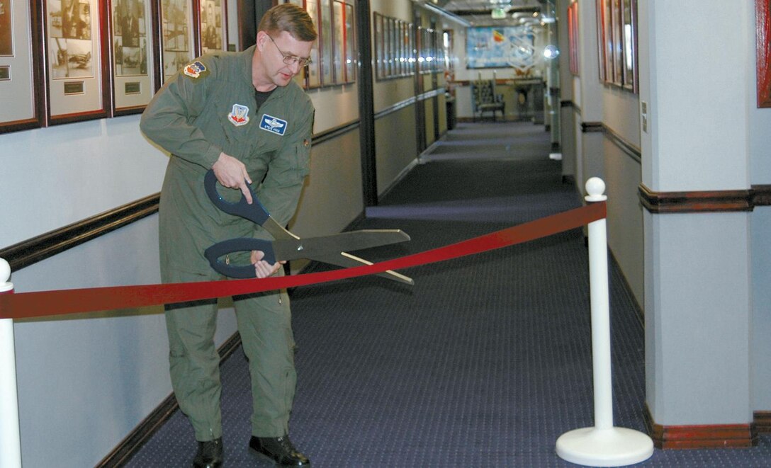 Brig. Gen. Stephen Hoog, Air Expeditionary Force Center commander, cuts the ribbon to open the renovated388th FW command section.