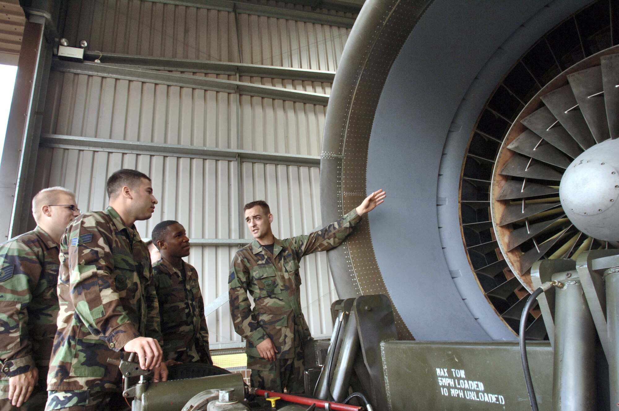 Staff Sgt. Erik Lucas (right) trains Tech. Sgt. Douglas Younts (left to right) and Senior Airmen Pablo Londono and Erick Combs on how to inspect an engine at Royal Air Force Mildenhall, England, on July 31. The Airmen are with the 727th Air Mobility Squadron. The squadron keeps and maintains spare C-5 Galaxy engines in case a visiting transport needs an engine swap. Each engine produces 43,000 pounds thrust, weighs 7,900 pounds and is nearly 27 feet long. (U.S. Air Force photo/Master Sgt. Lance Cheung)