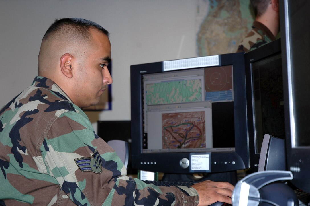 Senior Airman Javier Acosta works in the flight weather briefing cell at the 25th Operational Weather Squadron at Davis-Monthan Air Force Base, Ariz. The weather cell distributes various weather briefings to pilots and mission planners. (U.S. Air Force photo/Miles Brown)