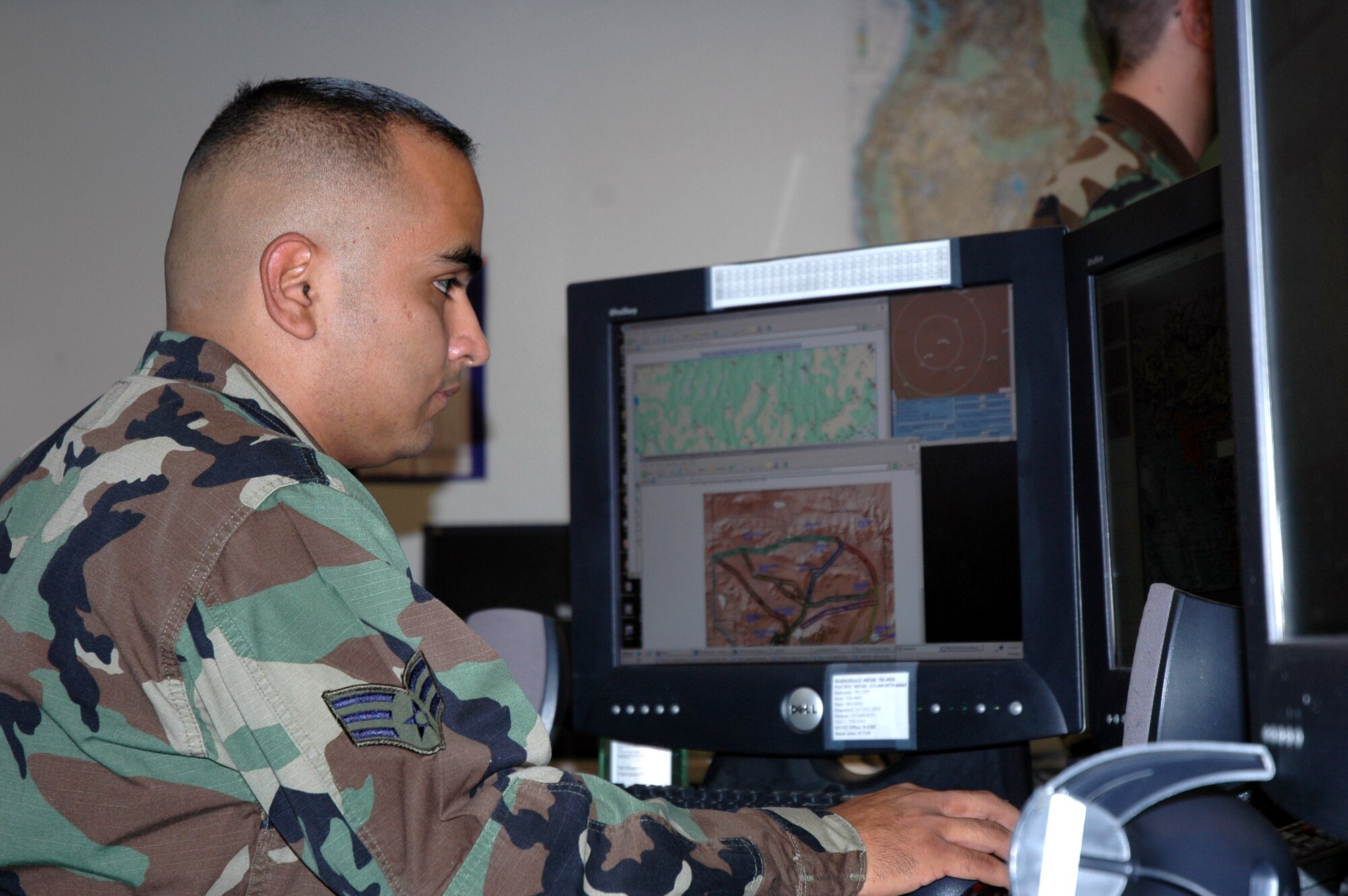Senior Airman Javier Acosta works in the flight weather briefing cell at the 25th Operational Weather Squadron at Davis-Monthan Air Force Base, Ariz. The weather cell distributes various weather briefings to pilots and mission planners. (U.S. Air Force photo/Miles Brown)