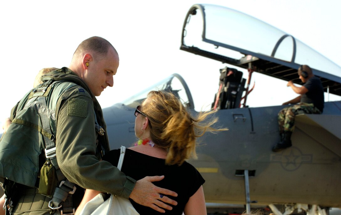 Capt. Matt Johnson, an F-15 Eagle pilot with the 71st Fighter Squadron, is welcomed home by his wife, Landell, upon his return to Langley Air Force Base, Va., on July 28. Captain Johnson had been on temporary duty in Savannah, Ga. The 27th, 71st and 94th Fighter Squadrons have been flying sorties and participating in exercises around the country while upgrade repairs were being done to their home runway. (U.S. Air Force photo/Staff Sgt. Samuel Rogers)
