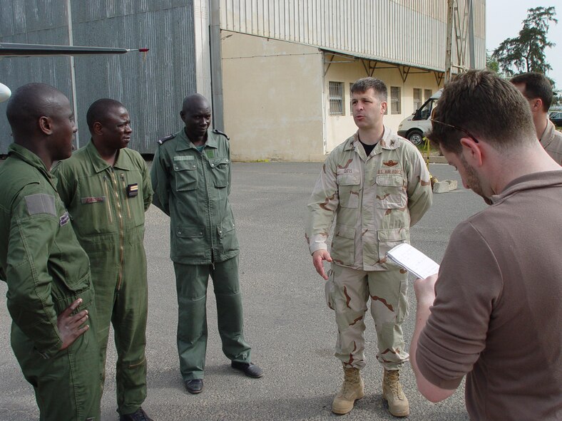 Col. Brian Cutts, right, 352nd Special Operations Group deputy commander, discusses aircraft and local capabilities of the Senegalese Air Force, with Senegalese Air Force officers at Dakar International Airport June 12.  (U.S. Air Force photo by Master Sgt. Dennis Brewer)