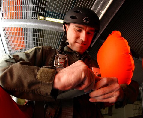Capt. Shawn Timpson, a KC-135 pilot with the 351st Air Refueling Squadron, puts on a flotation device before beginning water-survival training June 8 at Lowestoft College in Lowestoft. Survival, evasion, resistance and escape instructors from RAFs Mildenhall and Lakenheath offer water-survival training to aircrew members once a month at the college. It is a refresher course during which aircrew members learn how to survive after a crash landing in water. The training is mandatory for all aircrew members once every two-to-three years. (U.S. Air Force photo by Staff Sgt. Tyrona Pearsall)
