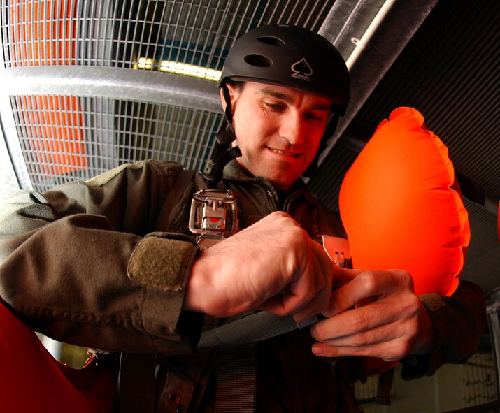 Capt. Shawn Timpson, a KC-135 pilot with the 351st Air Refueling Squadron, puts on a flotation device before beginning water-survival training June 8 at Lowestoft College in Lowestoft. Survival, evasion, resistance and escape instructors from RAFs Mildenhall and Lakenheath offer water-survival training to aircrew members once a month at the college. It is a refresher course during which aircrew members learn how to survive after a crash landing in water. The training is mandatory for all aircrew members once every two-to-three years. (U.S. Air Force photo by Staff Sgt. Tyrona Pearsall)
