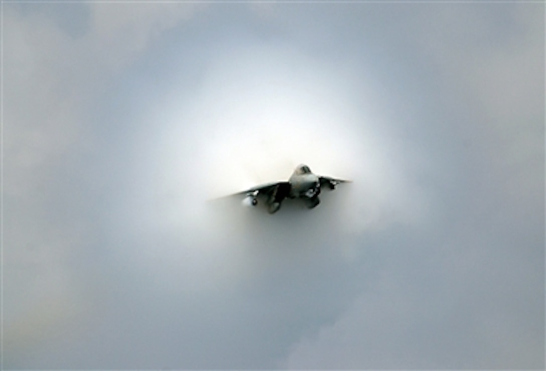 A Navy F-14D Tomcat makes a near supersonic fly-by above the flight deck of the USS Theodore Roosevelt (CVN 71) during the final launch of Tomcats as the ship operates in the Atlantic Ocean on July 28, 2006.  The F-14 will officially retire in September 2006 after 32 years of service to the fleet.  This Tomcat is assigned to Fighter Squadron 31.  