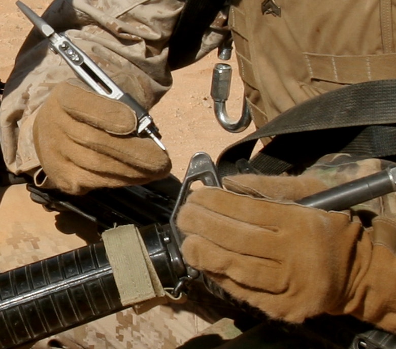 Cpl. Valerie Gavaldon helps a member of the Lioness Program adjust the front site post on her M16A2 service rifle, during the live-fire portion of their training at Camp Korean Village, Iraq, July 31. Eight female Marines from different units within 3rd Marine Aircraft Wing volunteered for the Lioness Program to conduct security searches of women crossing into Iraq. Gavaldon is a combat engineer, Marine Wing Support Squadron 274, Marine Wing Support Group 37 (Reinforced), 3rd MAW, and an El Paso, Texas native.