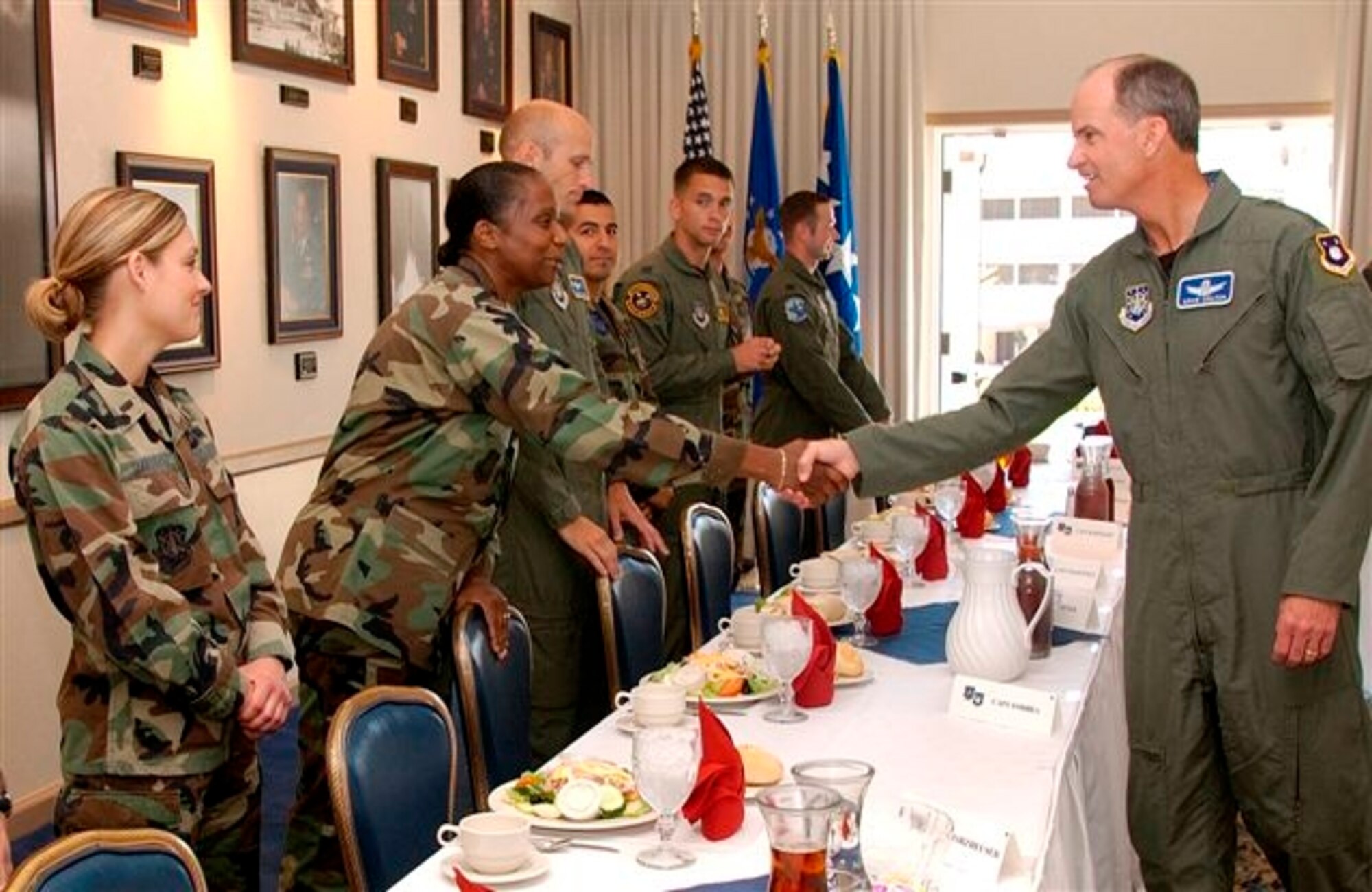 Capt. Alida Forbes, 4th Space Launch Squadron, shakes hands with Gen. Kevin P. Chilton, commander, Air Force Space Command, during a company grade officer luncheon at Vandenberg Air Force Base, Calif., July 20. (Air Force photo by Staff Sgt. Samuel Bendet)   