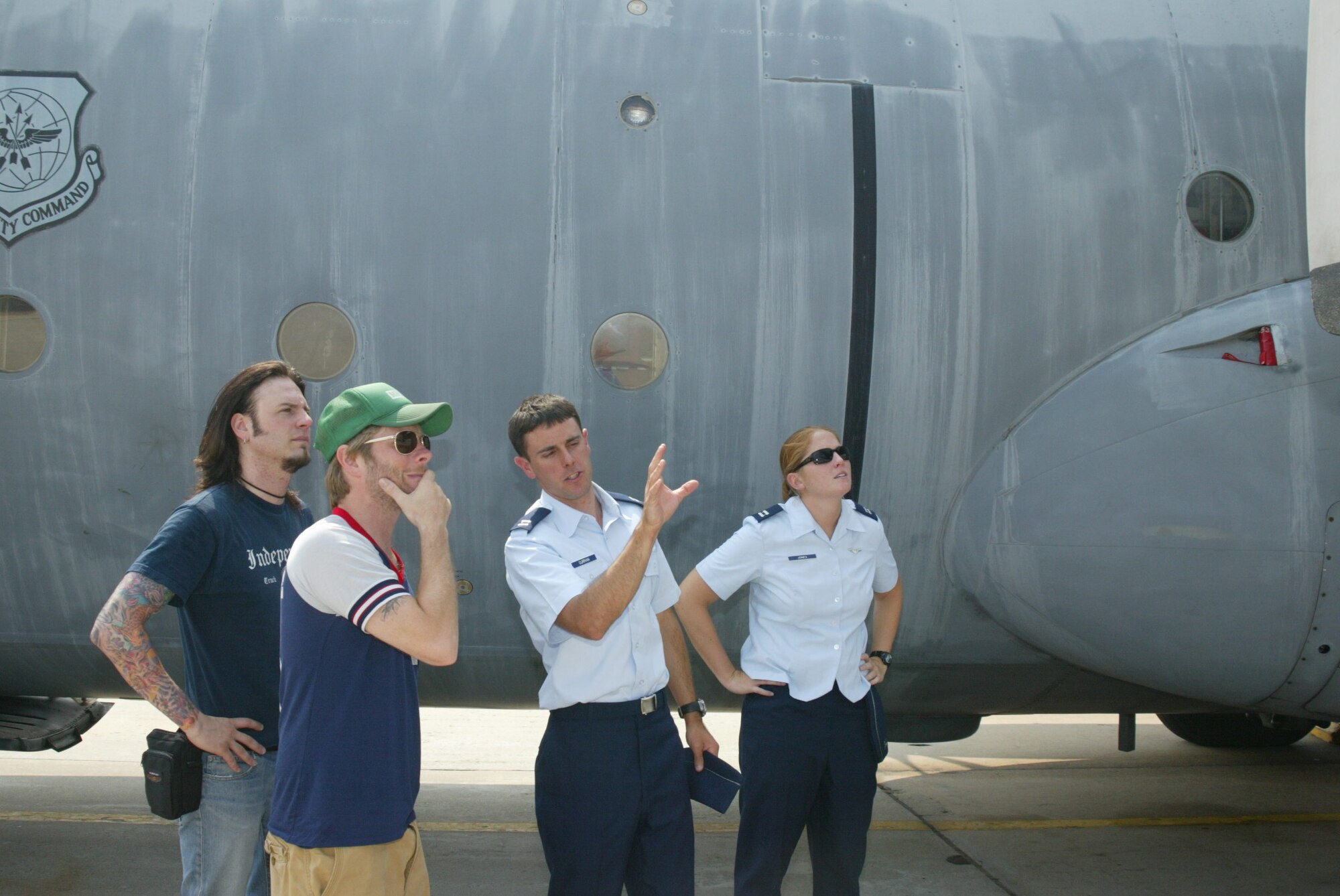 Capt. Douglas Curran and Capt. Stacy Jones, both from the 41st Airlift Squadron, show Hilary Duff?s guitarist, Jason Hook, and drummer, Luke Adams inside and outside of a C-130 aircraft. Ms. Duff performed for Air Force and Army troops at the Crown Coliseum in FayettevilleTuesday night. (U.S. Air Force photo/Senior Airman Cassandra Locke)