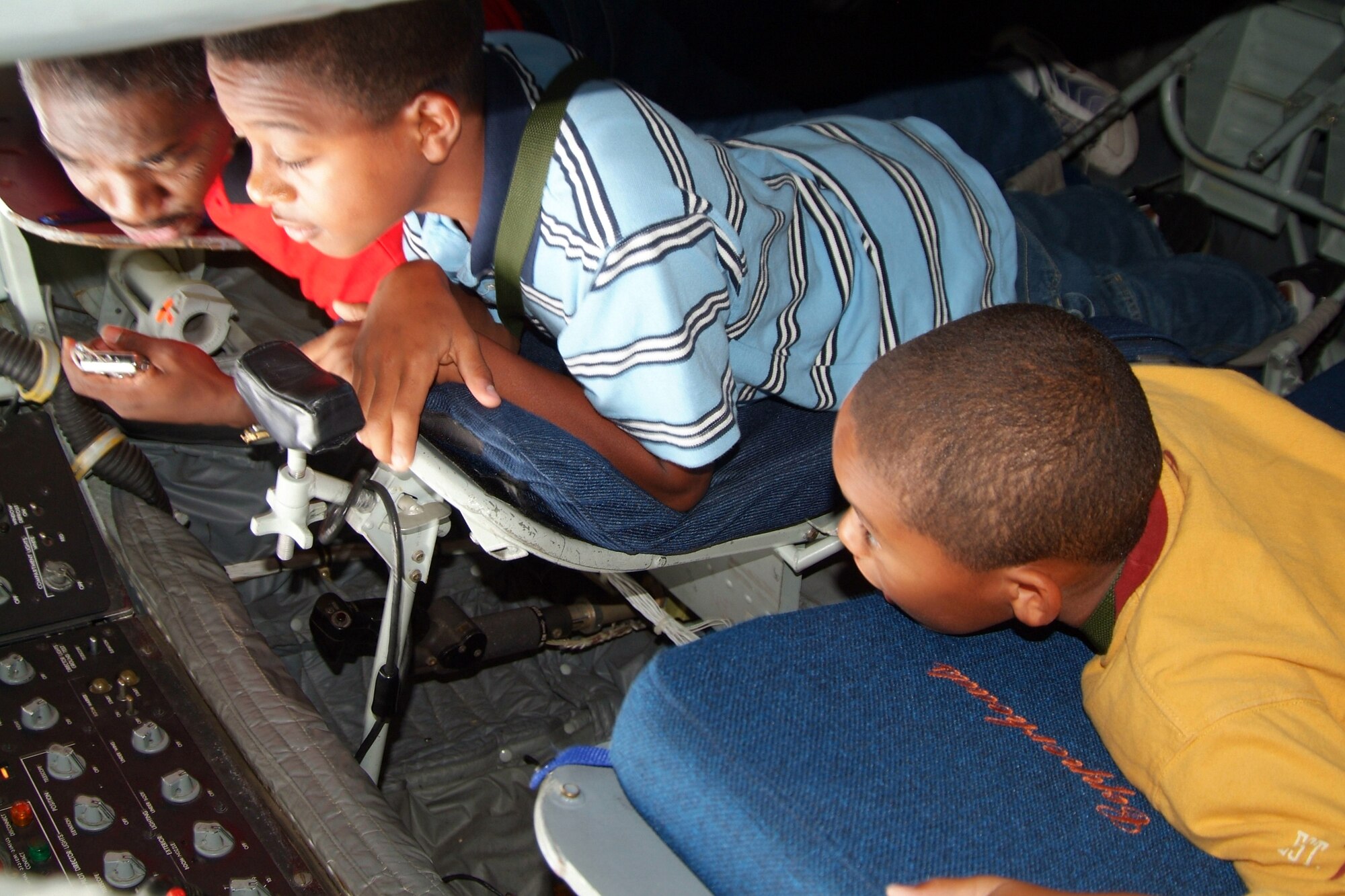 Mike Toliver (left) explains boom controls on a KC-135 Stratotanker to two Civil Air Patrol cadets during an incentive flight for students in the CAP and Aviation Careers Education Camp in Phoenix on Aug. 1. The flight was held in conjunction with the Tuskeegee Airman Convention. The aircraft is with the Arizona Air National Guard. (U.S. Air Force photo/Tech. Sgt. Joe Zuccaro)