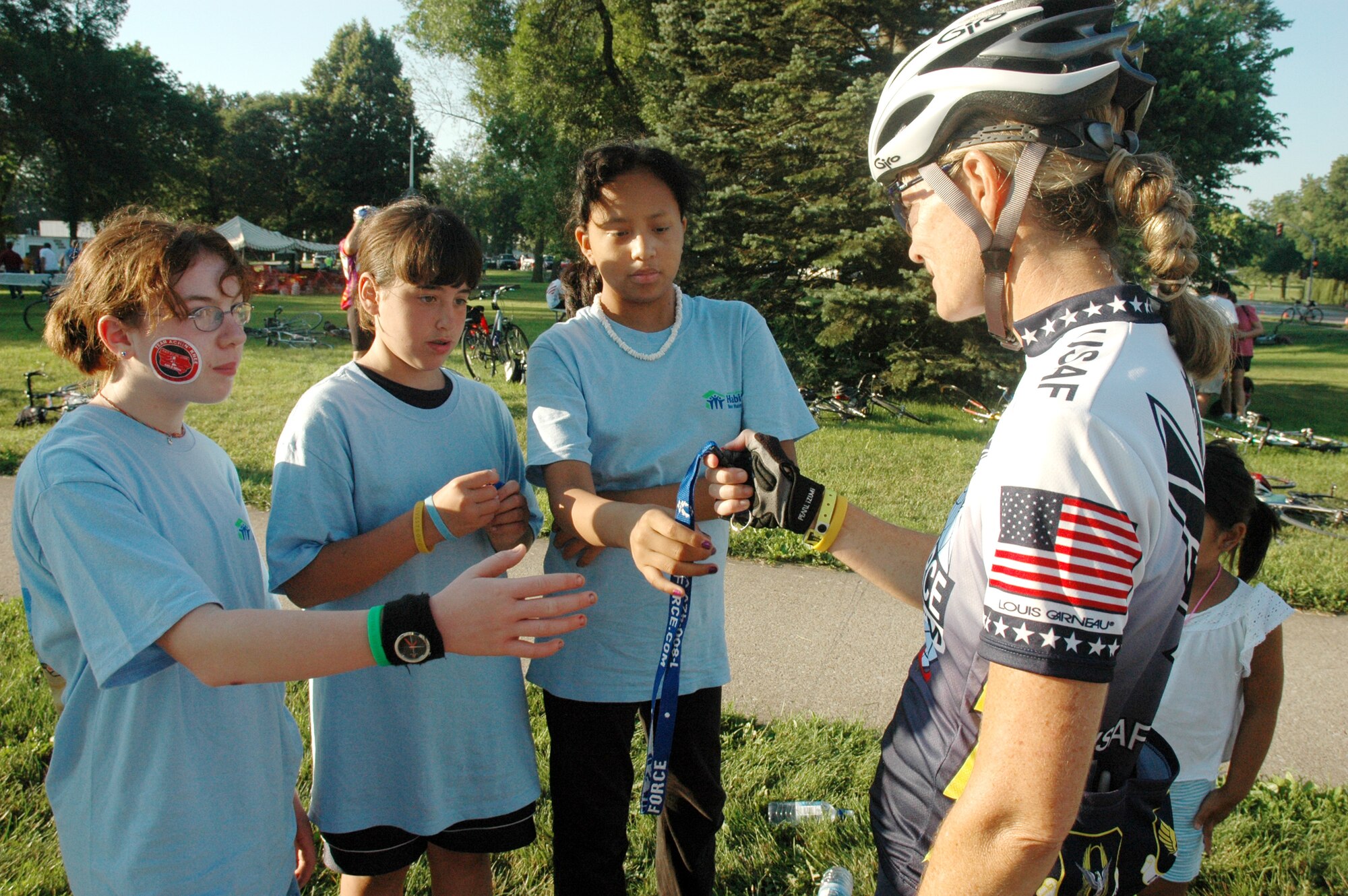 Lt. Col. Sheila Marcusen hands out Air Force promotional materials to girls in West Branch, Iowa, on July 29. The colonel was a member of the Air Force team taking part in the Des Moines Register's Annual Great Bike Ride Across Iowa. The Air Force team of cyclists participates in RAGBRAI in support of recruiting. Colonel Marcusen is with the U.S. Transportation Command at Scott Air Force Base, Ill. (U.S. Air Force photo/1st Lt. Kristen Duncan) 
