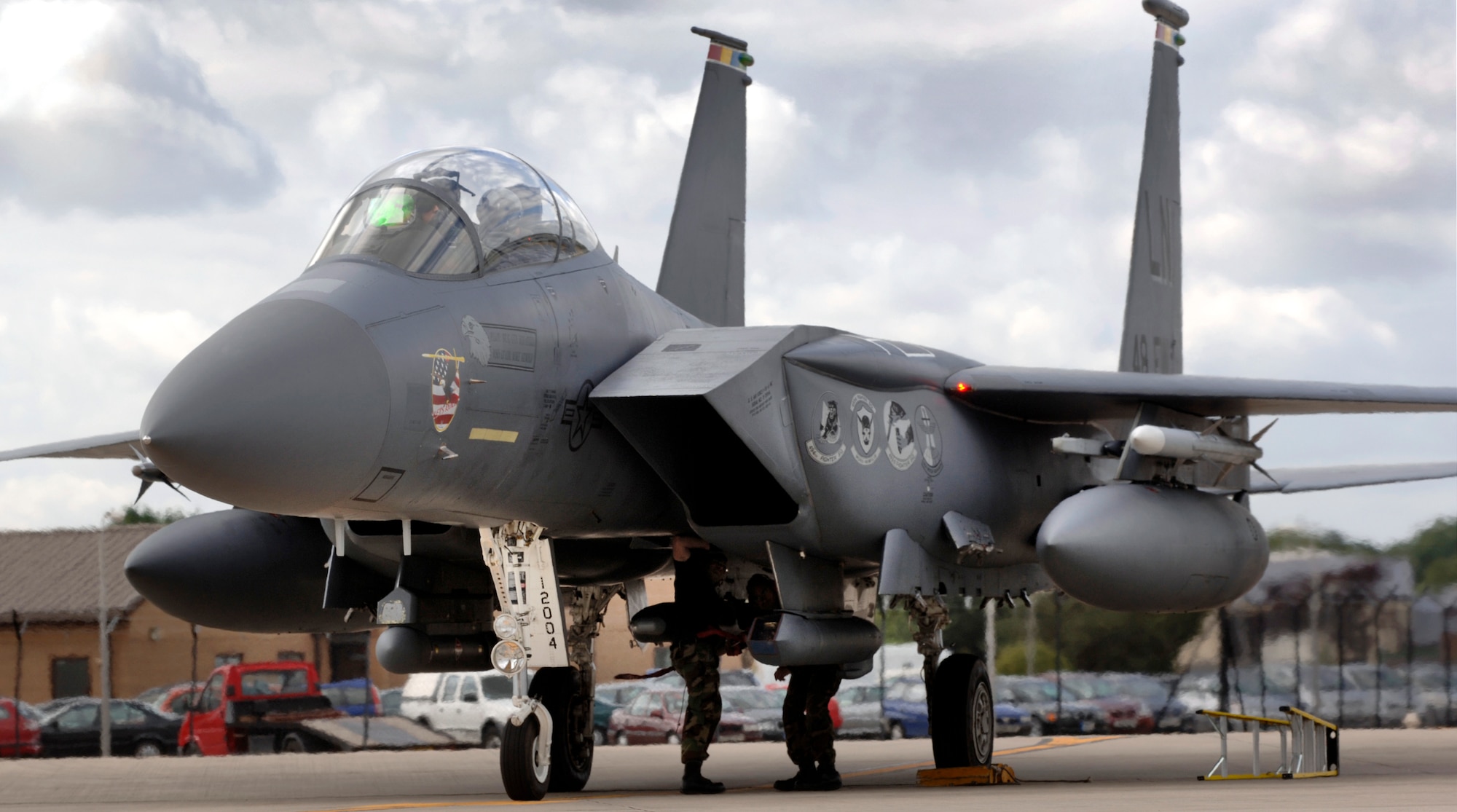 Airman 1st Class James Willett (left) and Staff Sgt. David Cruz disarm an F-15E Strike Eagle at Royal Air Force Base Lakenheath, England, on Aug. 1. The 494th Fighter Squadron jet had just returned from a training mission. The Airmen are weapons specialists with the 48th Aircraft Maintenance Squadron. (U.S. Air Force photo/Master Sgt. Lance Cheung) 
