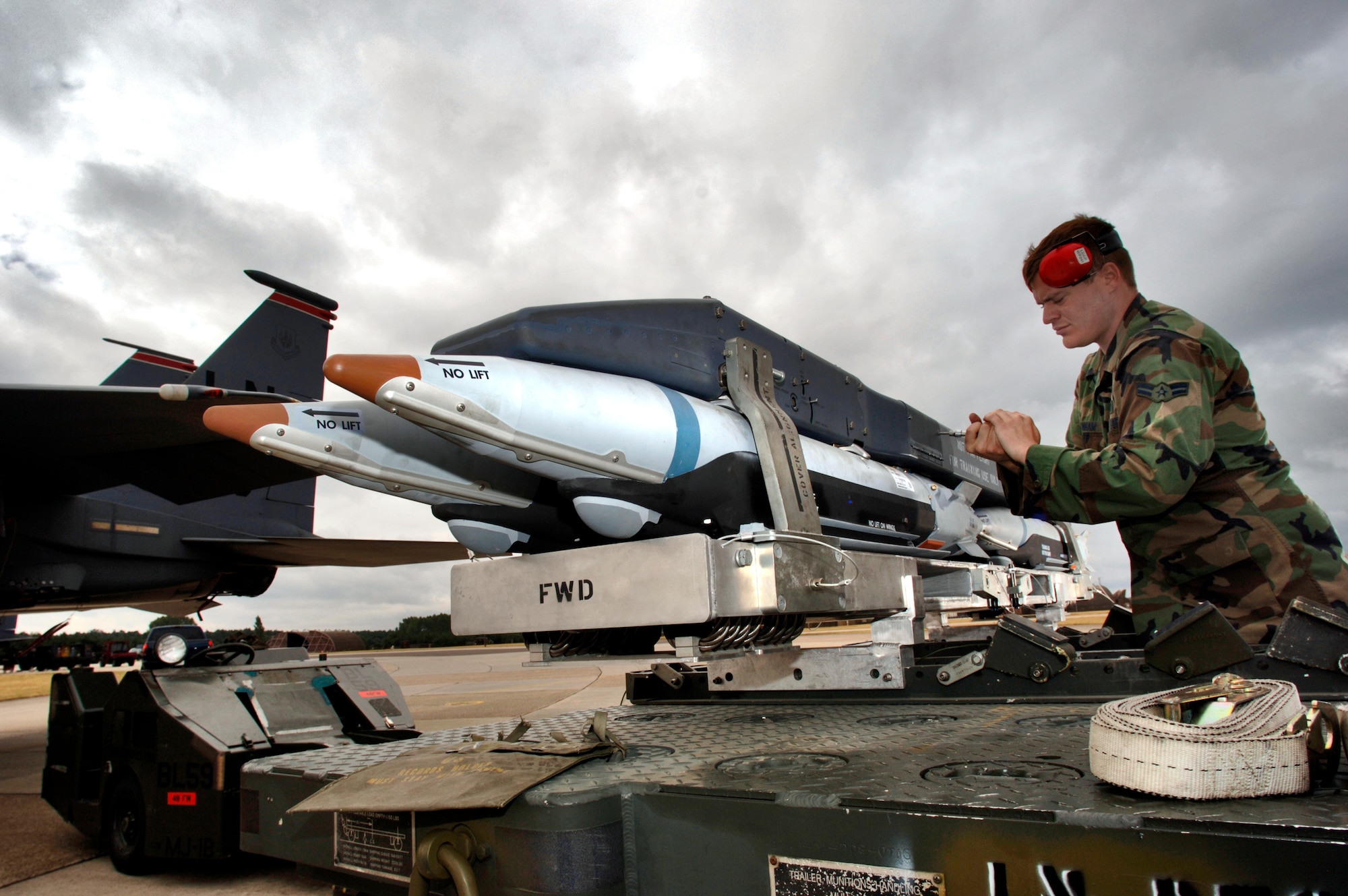 Airman 1st Class Robert Branham prepares a Bomb Rack Unit-61 for loading onto an F-15E Strike Eagle at Royal Air Force Lakenheath, England, on Aug. 1. The bomb rack and carrier comes loaded with Guided Bomb Unit-39 small-diameter bombs. The Airman is an aircraft weapons specialist with the 48th Aircraft Maintenance Squadron. (U.S. Air Force photo/Master Sgt. Lance Cheung) 