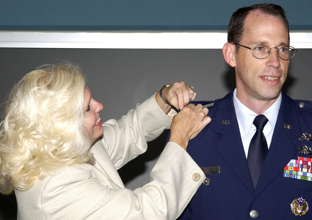 WRIGHT-PATTERSON AIR FORCE BASE, Ohio — Air Force Materiel Command executive director Barbara A. Westgate, a lieutenant general equivalent, pins the rank of colonel onto her husband, Lt. Col. Charles J. Westgate III, in what is believed to be the only such promotion of its kind to date in the Air Force. (Air Force photo by Michael Libecap)