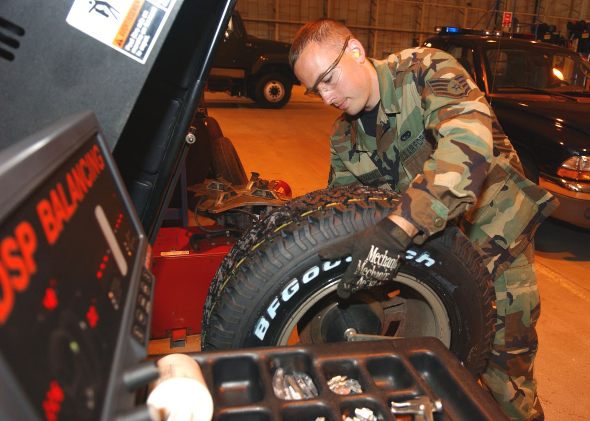 Staff Sgt. Dan Tiedmann balances a tire for a vehicle in the newly configured tire shop. Tires need to be replaced regularly to ensure the vehicle remains safe.  (U.S. Air Force photo by Staff Sgt. Tyrona Pearsall)