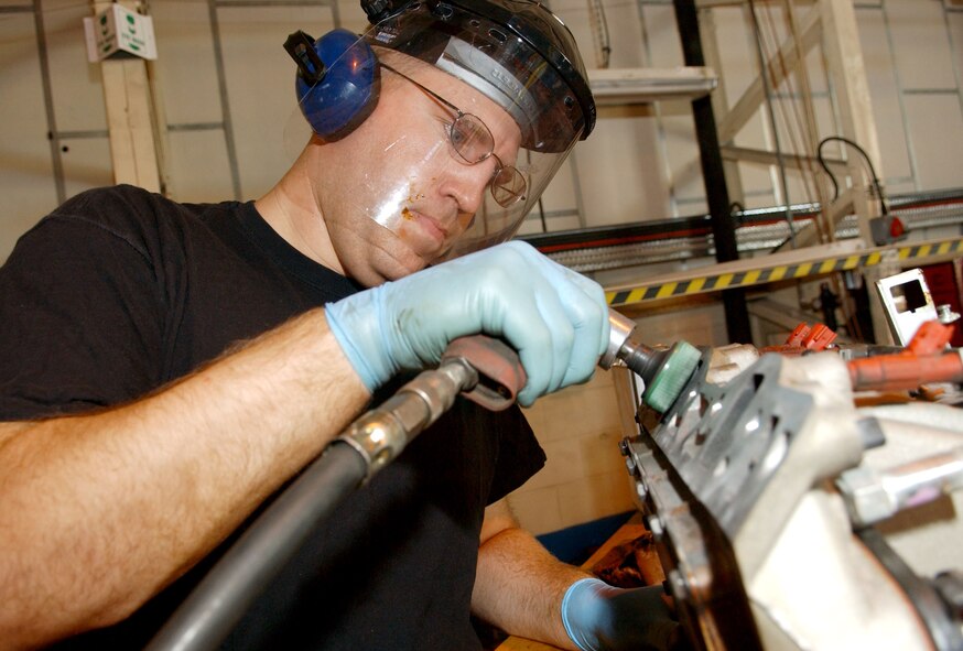 Airman 1st Class Mark Thomas removes a gasket from an engine piece. Gaskets ensure a there is a tight seal between two metal parts.  (U.S. Air Force photo by Staff Sgt. Tyrona Pearsall)