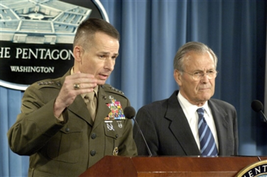 Chairman of the Joint Chiefs of Staff Gen. Peter Pace, U.S. Marine Corps, and Secretary of Defense Donald H. Rumsfeld field questions from reporters during a press briefing in the Pentagon in Arlington, Va., on Aug. 2, 2006.  Pace, recently back from a trip to Afghanistan, had a lot of praise for the American troops he visited there and favorable comments on the country's progress in its fight against terrorism.  