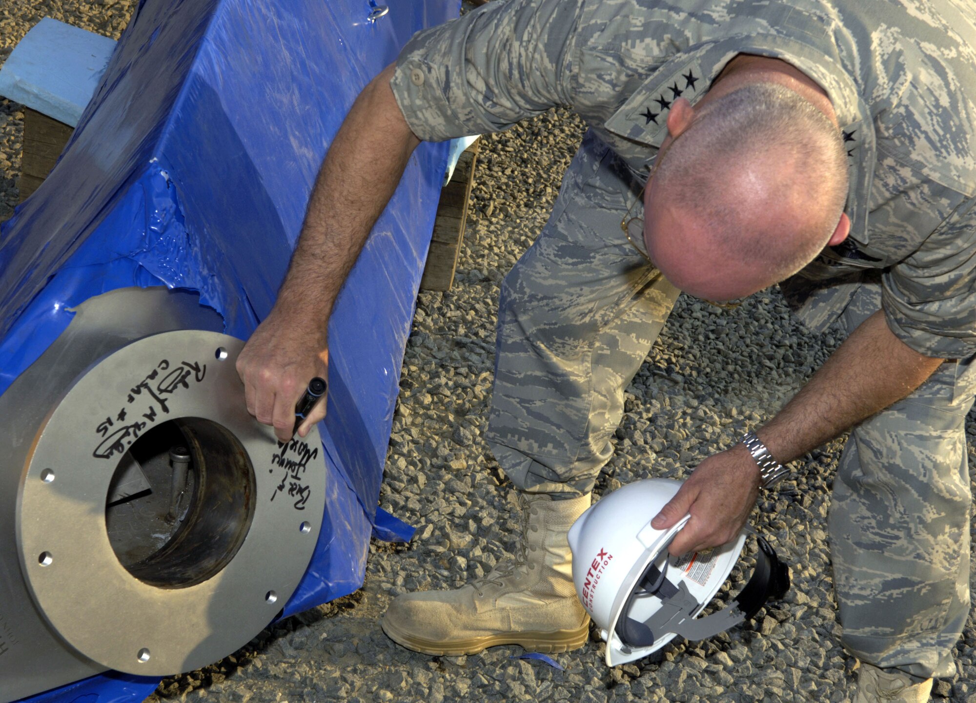 Chief of Staff of the Air Force Gen. T. Michael Moseley signs the tip of the last spire to be added to the Air Force Memorial in Arlington, Va. on Aug. 3.  The memorial is scheduled to be completed on Oct. 14.  (U. S. Air Force photo/Tech. Sgt. Cohen A. Young)