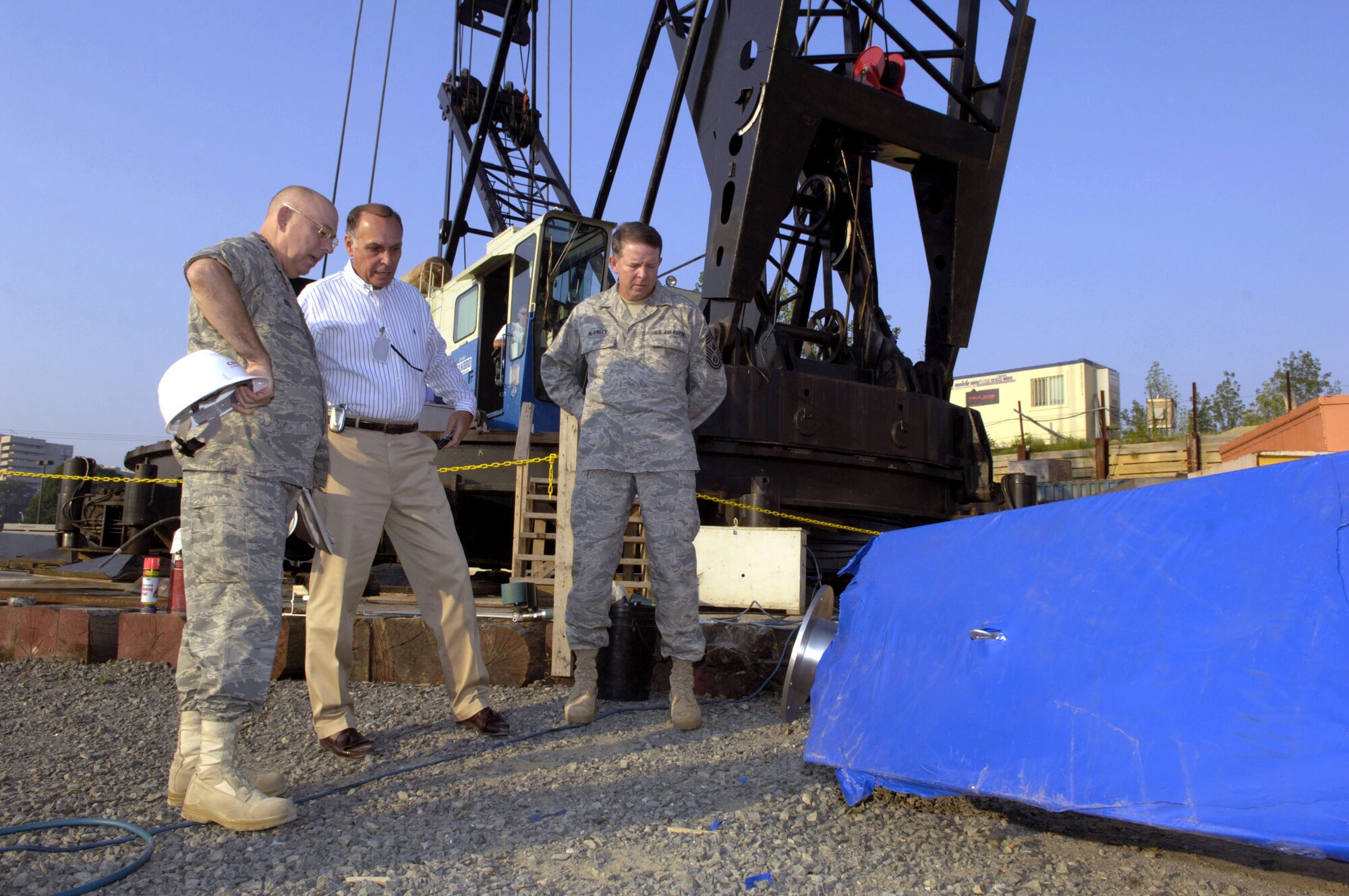 Retired Major Gen. Edward F. Grillo, Jr., Air Force Memorial Foundation president, shows Chief of Staff of the Air Force Gen. T. Michael Moseley and Chief Master Sergeant of the Air Force Rodney J. McKinley around the site of the Air Force Memorial during a visit to the site in Arlington, Va. Aug 3.  The memorial is scheduled to be completed on Oct. 14.  (U. S. Air Force photo/Tech. Sgt. Cohen A. Young)