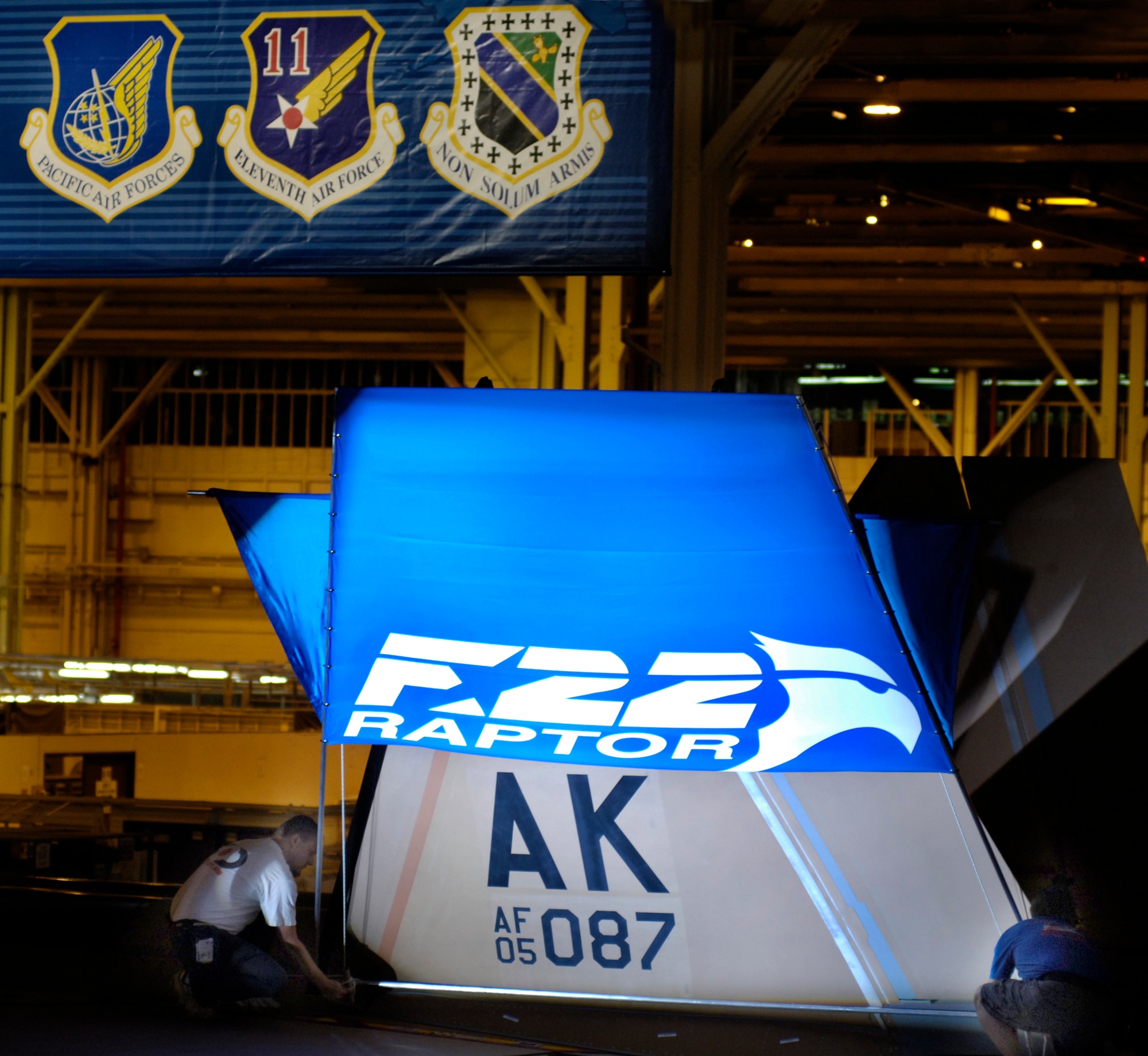 The tail section of an F-22 Raptor being assigned to Pacific Air Forces is prepared for an unveiling ceremony Aug 3 at the Lockheed Plant in Marietta, Ga.  The aircraft, which is still under construction, will be the first of 36 F-22s assigned to Elmendorf Air Force Base, Alaska, beginning next year.  (Courtesy photo/John Rossino)