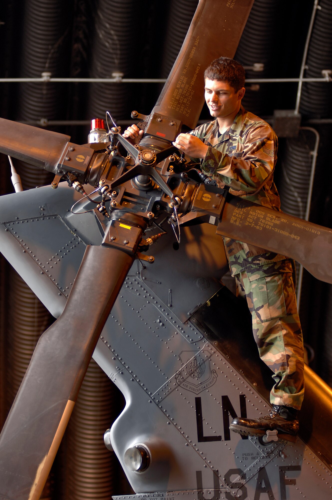 Airman 1st Class Antonio Yabarra inspects the tail rotor of an HH-60G Pave Hawk helicopter at Royal Air Force Lakenheath, England, on Aug. 2. The Airman is a crew chief with the 56th Aircraft Maintenance Unit. The unit supports the 56th Rescue Squadron, which moved to this fighter base from Keflavik Air Base, Iceland, in May. (U.S. Air Force photo/Master Sgt. Lance Cheung)