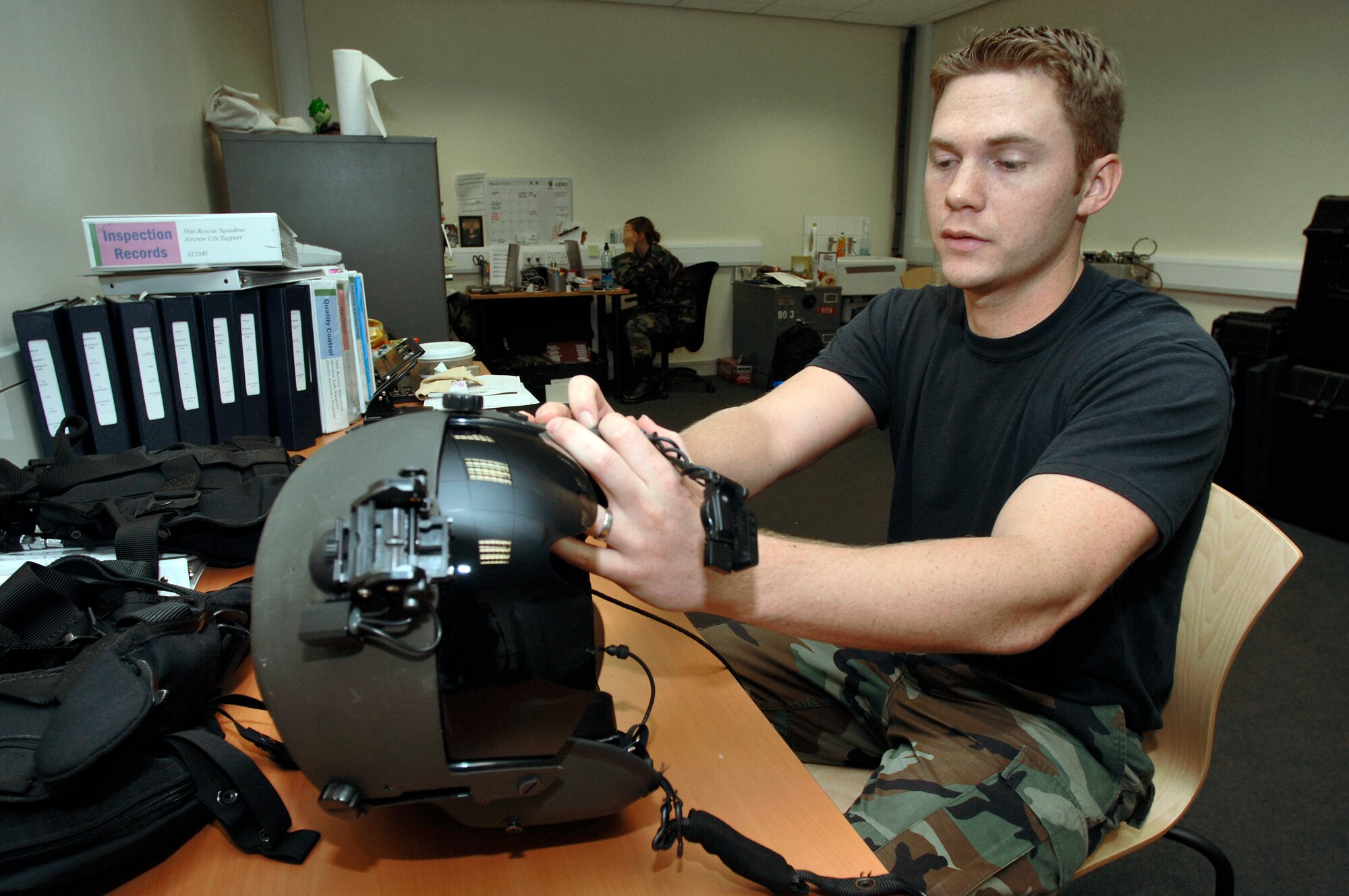 Staff Sgt. Brian Jasper inspects a flight helmet at Royal Air Force Lakenheath, England, on Aug. 2. The sergeant is a life support specialist with the 56th Rescue Squadron. The unit moved to this fighter base from Keflavik Air Base, Iceland, in May, and should be fully operational by mid-2007. (U.S. Air Force photo/Master Sgt. Lance Cheung)