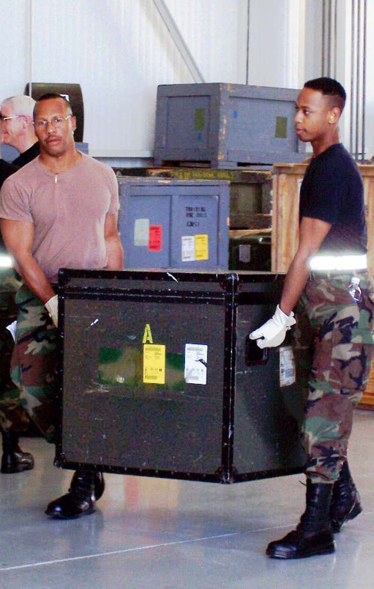 Master Sgt. Timothy Parker, left, and Senior Airman William Powell, air cargo transportation specialists, unload cargo while training at Dobbins ARB, Ga.