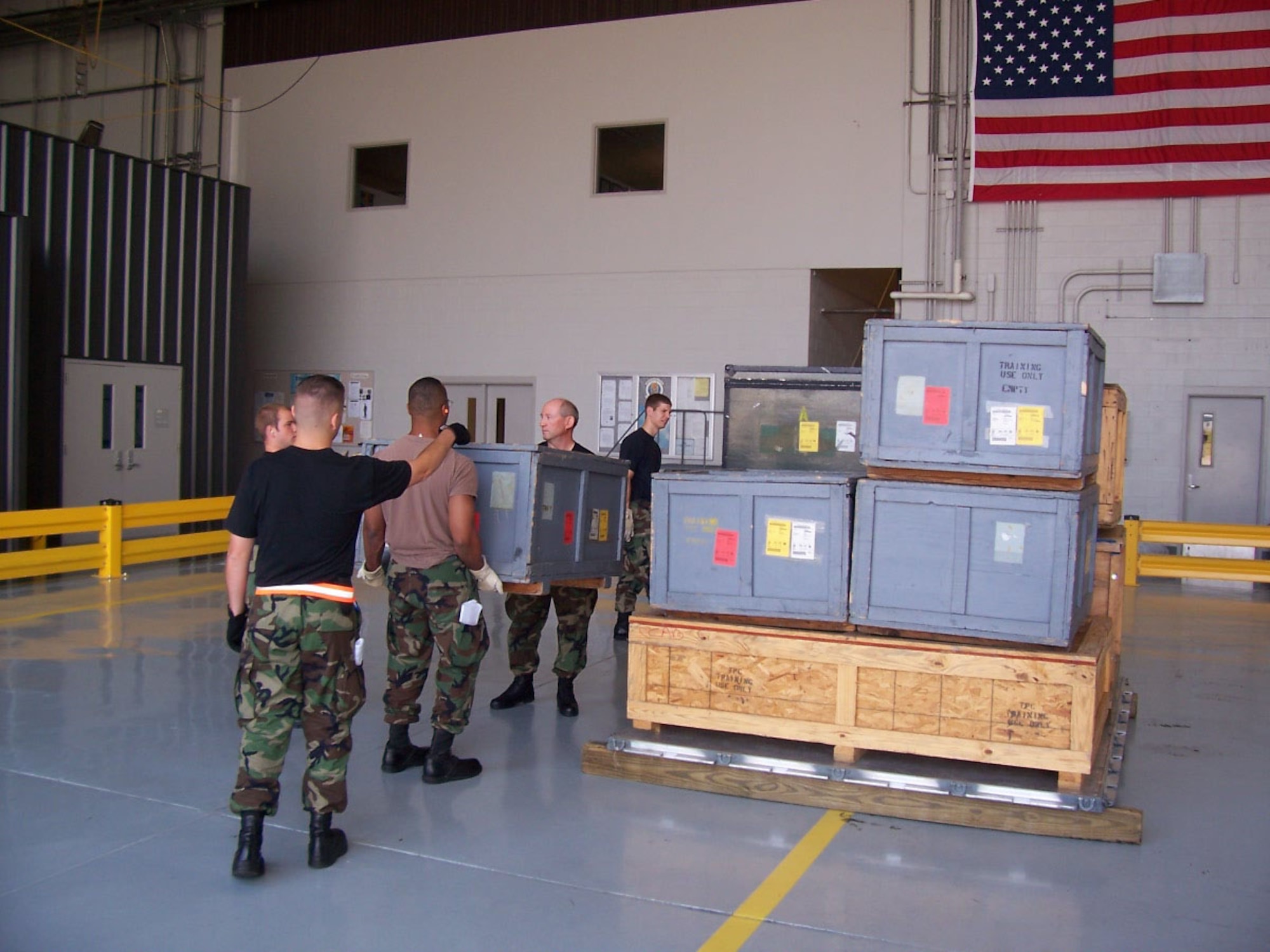 Members of the 72nd Aerial Port Squadron, 507th Air Refueling Wing, work together to load a pallet.