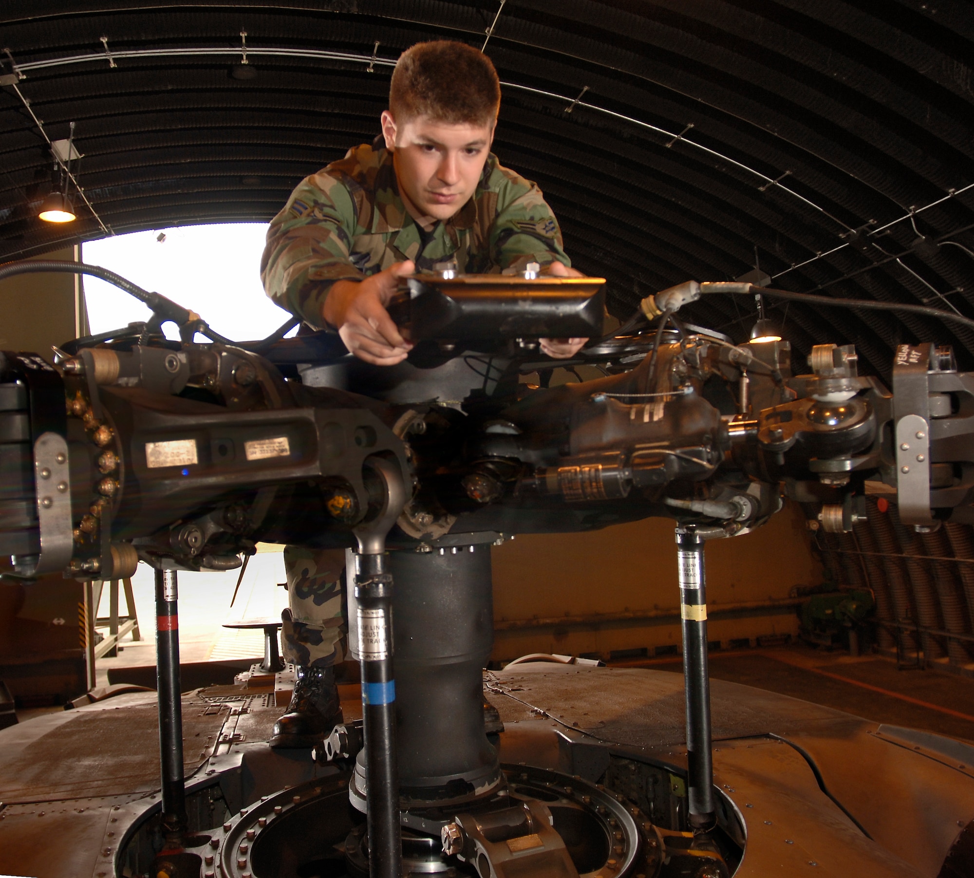 Airman 1st Class Matt Maurer inspects the main rotor of an HH-60 Pave Hawk helicopter at Royal Air Force Lakenheath, England, on Aug. 2. The Airman is with the 56th Aircraft Maintenance Unit. The unit supports the 56th Rescue Squadron, which moved to this fighter base from Keflavik Air Base, Iceland, in May. (U.S. Air Force photo/Master Sgt. Lance Cheung)