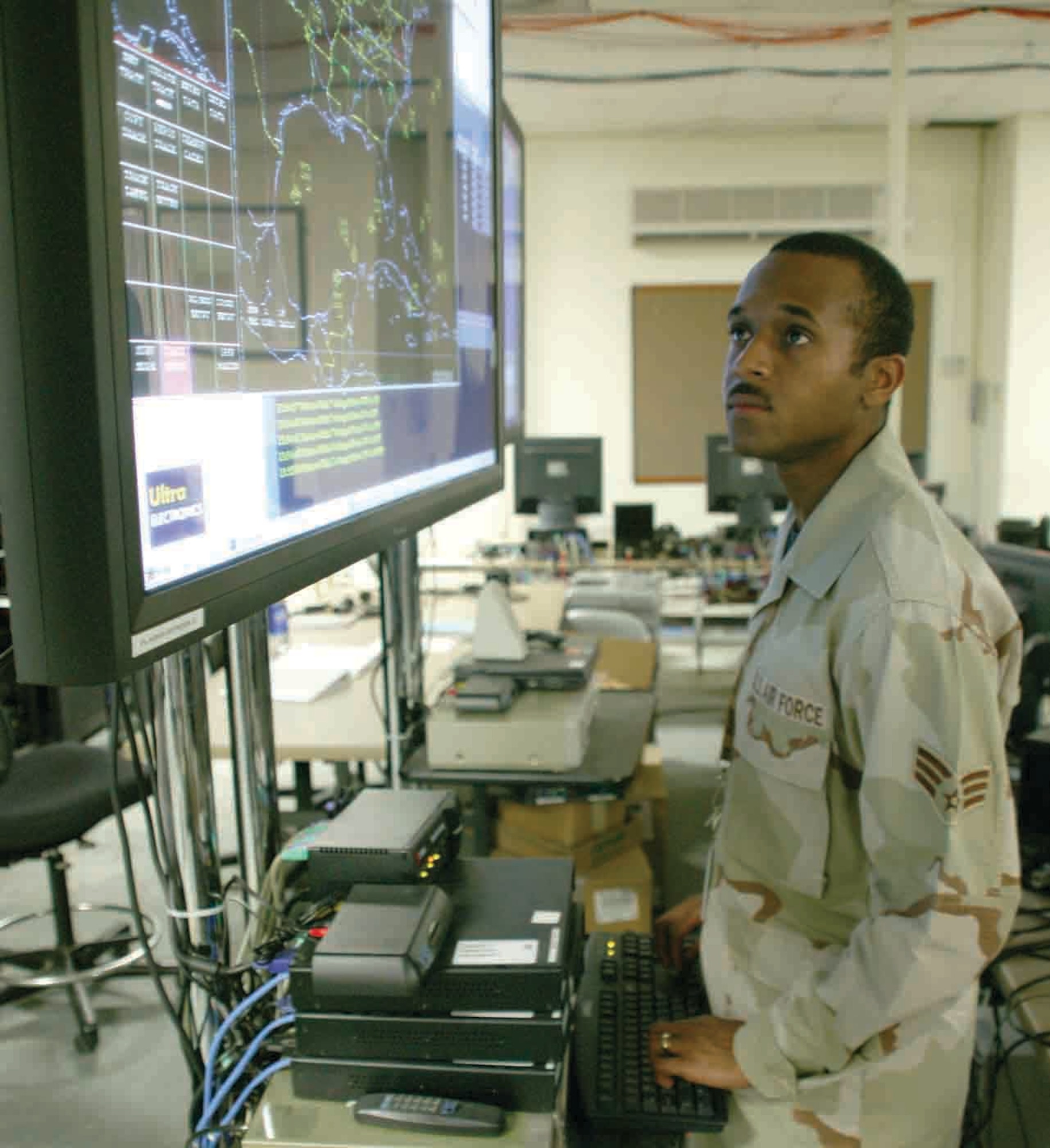 Senior Airman Calvin Carnathan, 609th COS interface control technician, brings up the Air Defense System Integrator.  The ADSI shows what links are up and down.  It also shows aircraft movement in the area of responsibility.  (U.S. Air Force photo/Senior Airman John Gordinier)