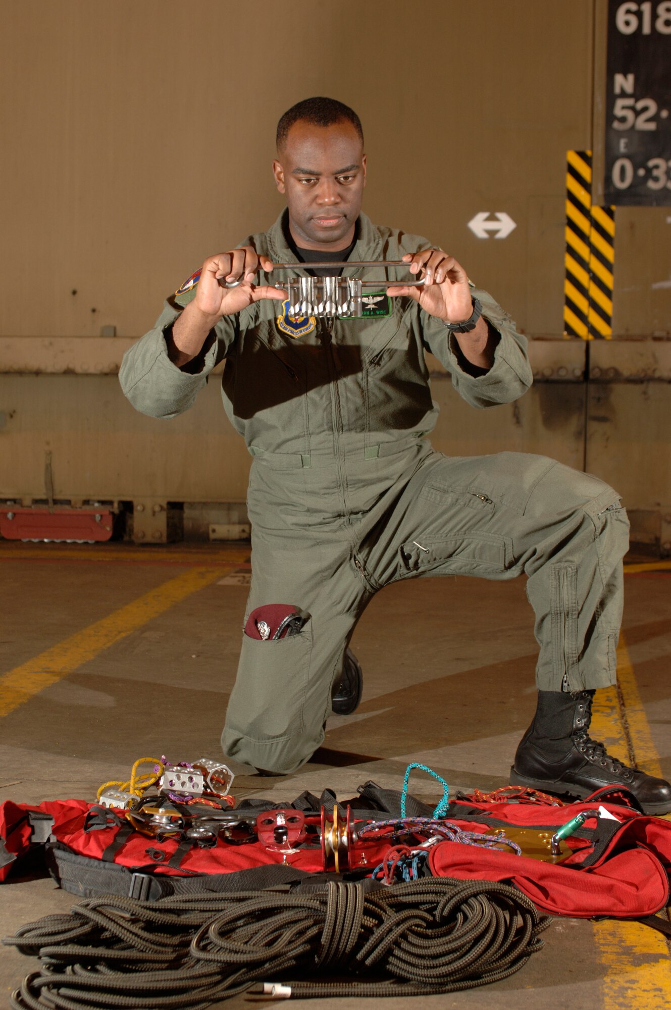 Staff Sgt. Kipran Wise inspects mountaineering gear at Royal Air Force Lakenheath, England, on Aug. 2. The sergeant is a pararescueman with the 56th Rescue Squadron. The unit moved to this fighter base from Keflavik Air Base, Iceland, in May. (U.S. Air Force photo/Master Sgt. Lance Cheung)