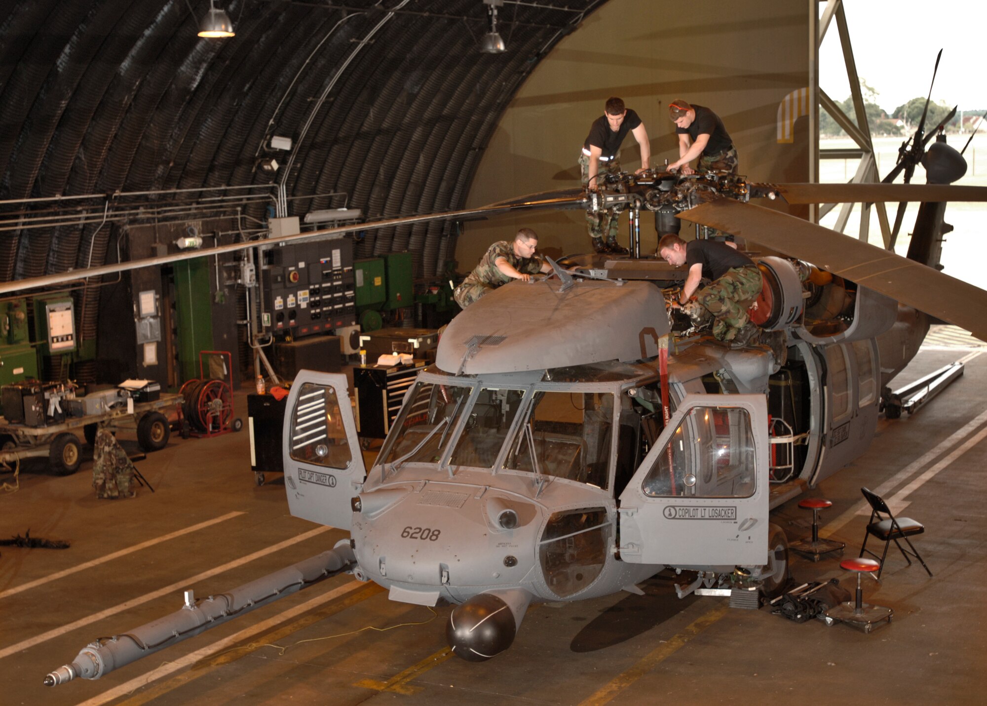 (Clockwise from left) Staff Sgt. Cleve Bury, Airmen 1st Class Antonio Yabarra and Jake Sexton and Senior Airman William Simpson work on an HH-60G Pave Hawk helicopter at Royal Air Force Lakenheath, England, on Aug. 2. The Airmen are crew chiefs with the 56th Aircraft Maintenance Unit. (U.S. Air Force photo/Master Sgt. Lance Cheung) 
