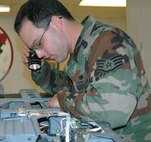 Staff Sgt. Antonio Moran, 388th Component Maintenance Squadron Aircrew Egress Systems craftsman,completes a visual inspection of an ejection seat using a flashlight.