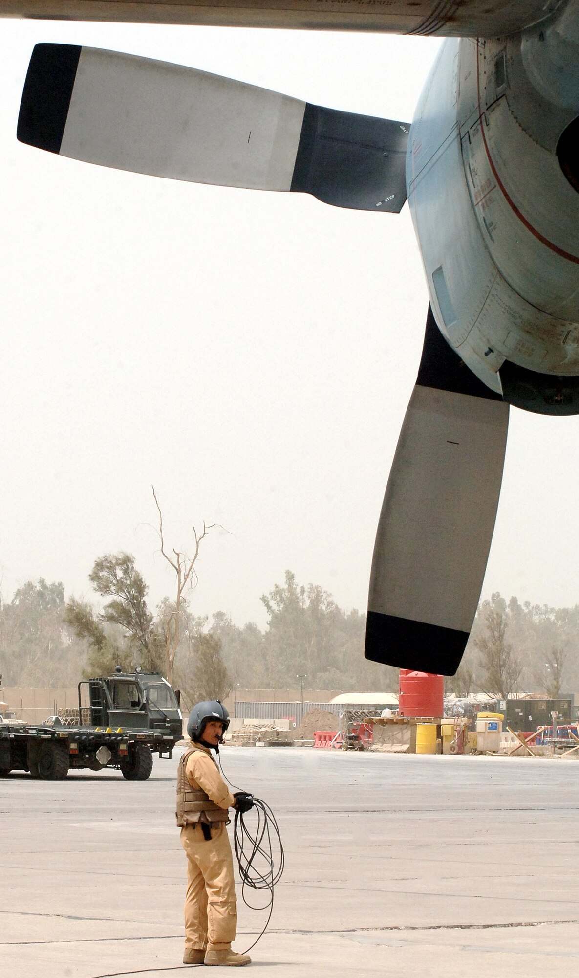 An Airman from the 447th Air Expeditionary Group loads a baggage pallet onto a Japan Air Self Defense Force C-130 on the ramp at Sather Air Base, Iraq, on July 31. The aircraft was the first of its kind from Japan to land at Baghdad International Airport. The blue C-130, painted that way for its affiliation with the United Nations, will now be a regular sight at Sather. (U.S. Air Force photo/Staff Sgt. Bryan Bouchard) 
