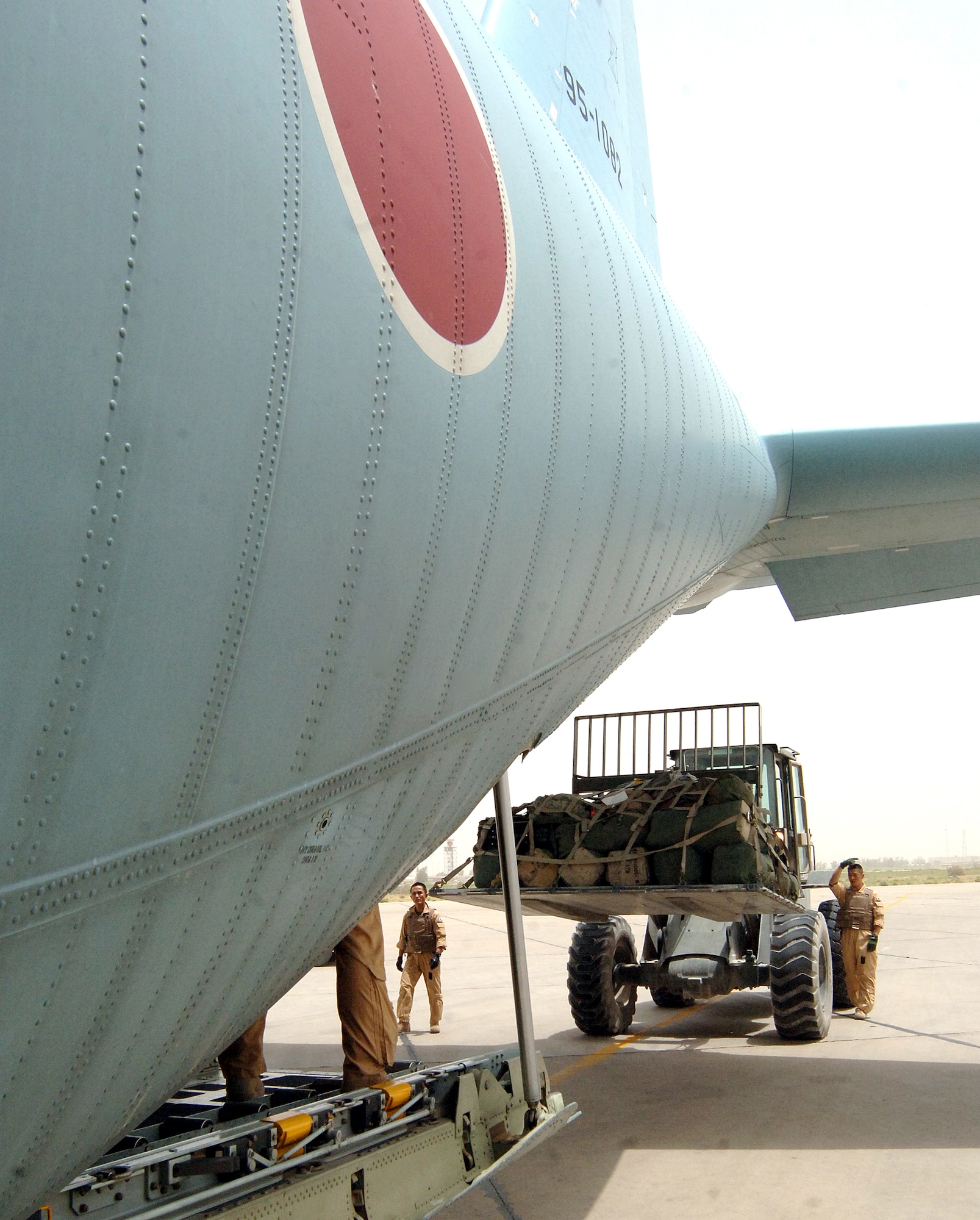 An airman from the Japan Air Self Defense Force stands outside his C-130 on the ramp at Sather Air Base, Iraq, on July 31. This marked the first time a Japanese C-130 had landed at Sather on Baghdad International Airport. The Japanese are now flying into Sather on a regular basis. (U.S. Air Force photo/Staff Sgt. Bryan Bouchard) 
