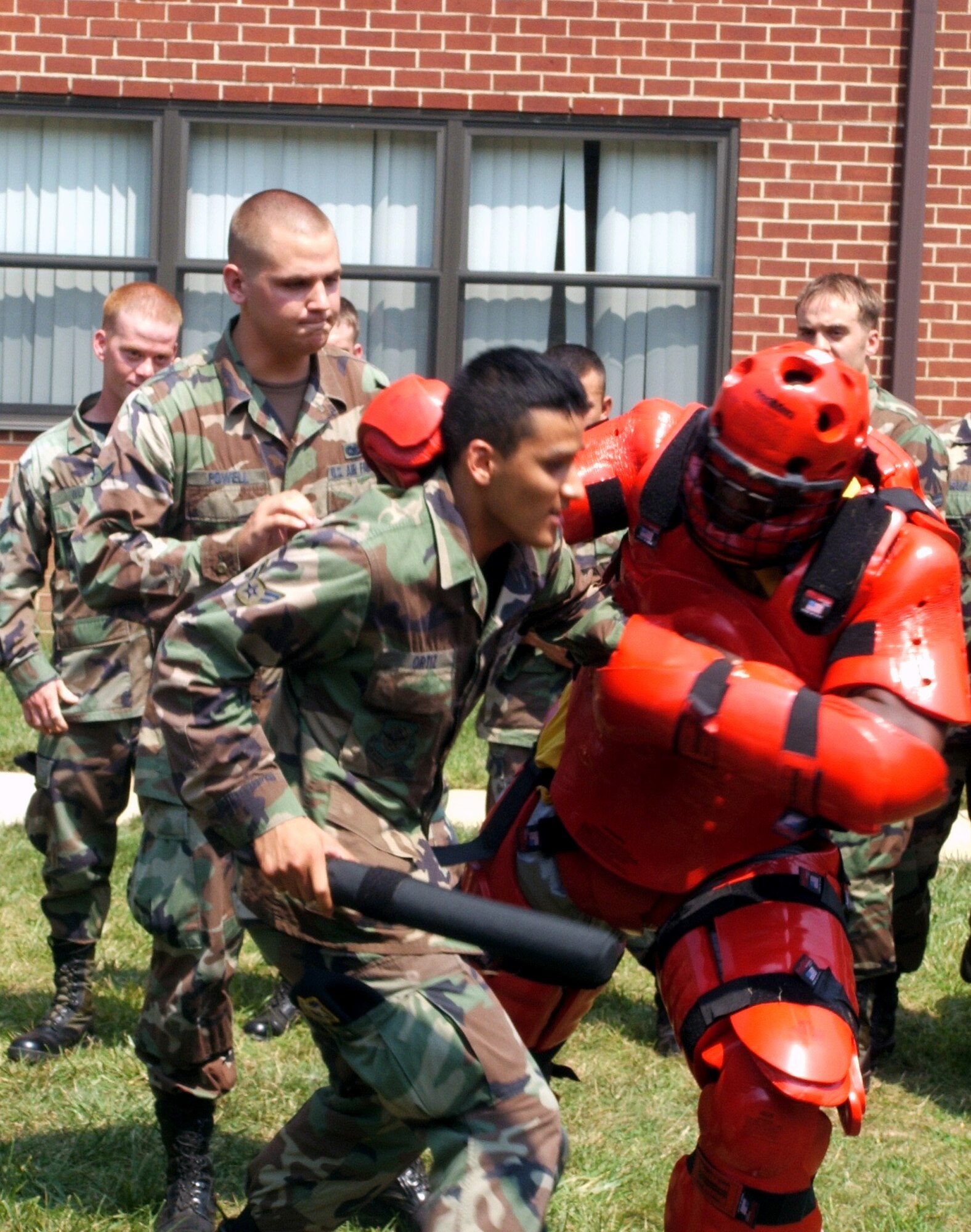 Airman 1st Class Guillermo Ortiz and Airman Coleman Powell participate in a training scenario with an aggressor in a "red man" suit during the Phoenix Raven course at Fort Dix, N.J., on Aug. 1. The course, taught by the Air Mobility Warfare Center's 421st Combat Training Squadron staff, trains security forces in use of force, anti-hijacking measures and aircraft security. Airman Ortiz is a security forces journeyman with the 437th Security Forces Squadron at Charleston Air Force Base, S.C. Airman Powell is a security forces journeyman from the 377th SFS at Kirtland AFB, N.M. (U.S. Air Force photo/Tech. Sgt. Scott T. Sturkol)