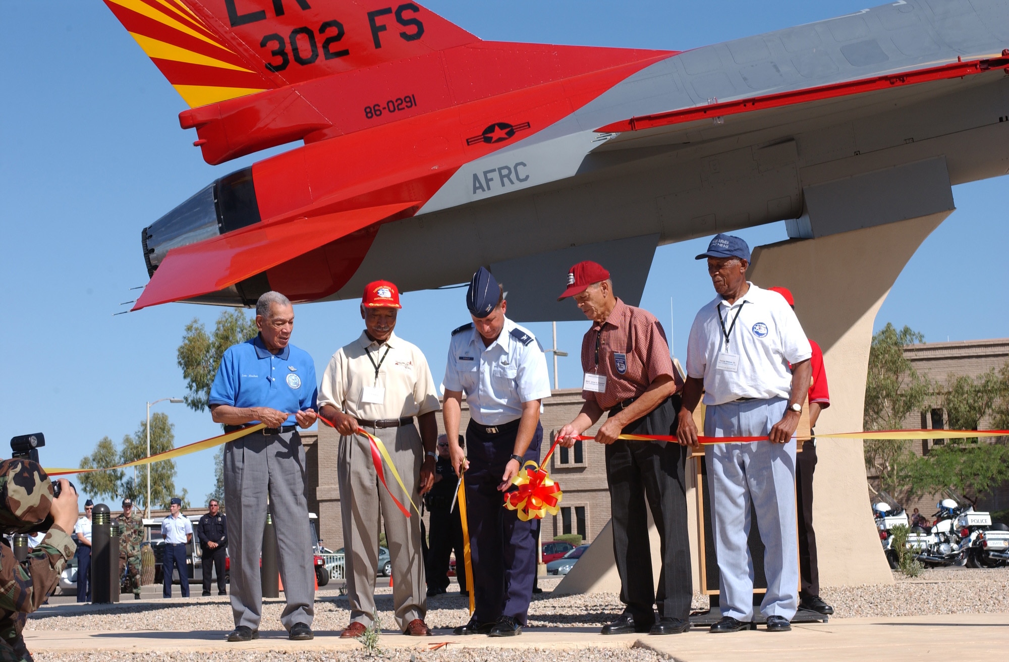(From left) Lt. Col. Lee Archer, Lt. Col. Robert Asbhy, Col. Derek Rydholm, Master Sgt. James Sheppard, and Tech. Sgt. George Watson participate in the ribbon cutting ceremony for the Tuskegee Airmen Memorial Airpark dedciation ceremony Aug. 2, 2006. (U.S. Air Force photo/Senior Airman Christopher Hummel)                          