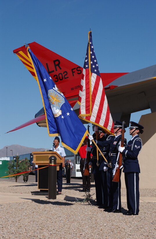 Master Sgt. Penny Young, 944th Fighter Wing, signs the National Anthem at the Tuskegee Airmen Airpark dedication ceremony as the 944th Fighter Wing honor guard presents the colors. (U.S. Air Force photo/Senior Airman Christopher Hummel)                               